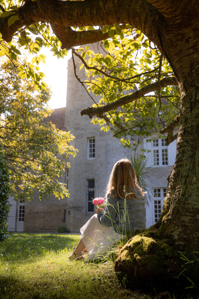 Child in front of the Medievale Tower of the Ranconniere firm hotel in Normandy