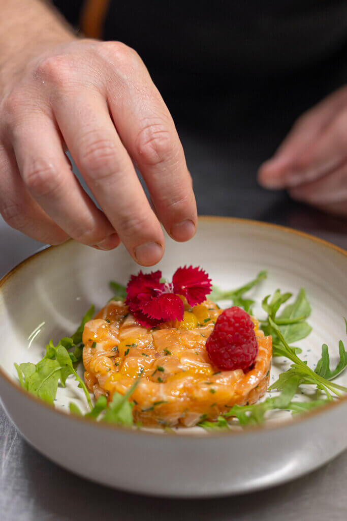 Tartare de saumon en préparation avec des produits frais au restaurant Ferme de la Ranconniere